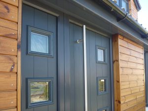 Close up of a black composite door with large bar handle