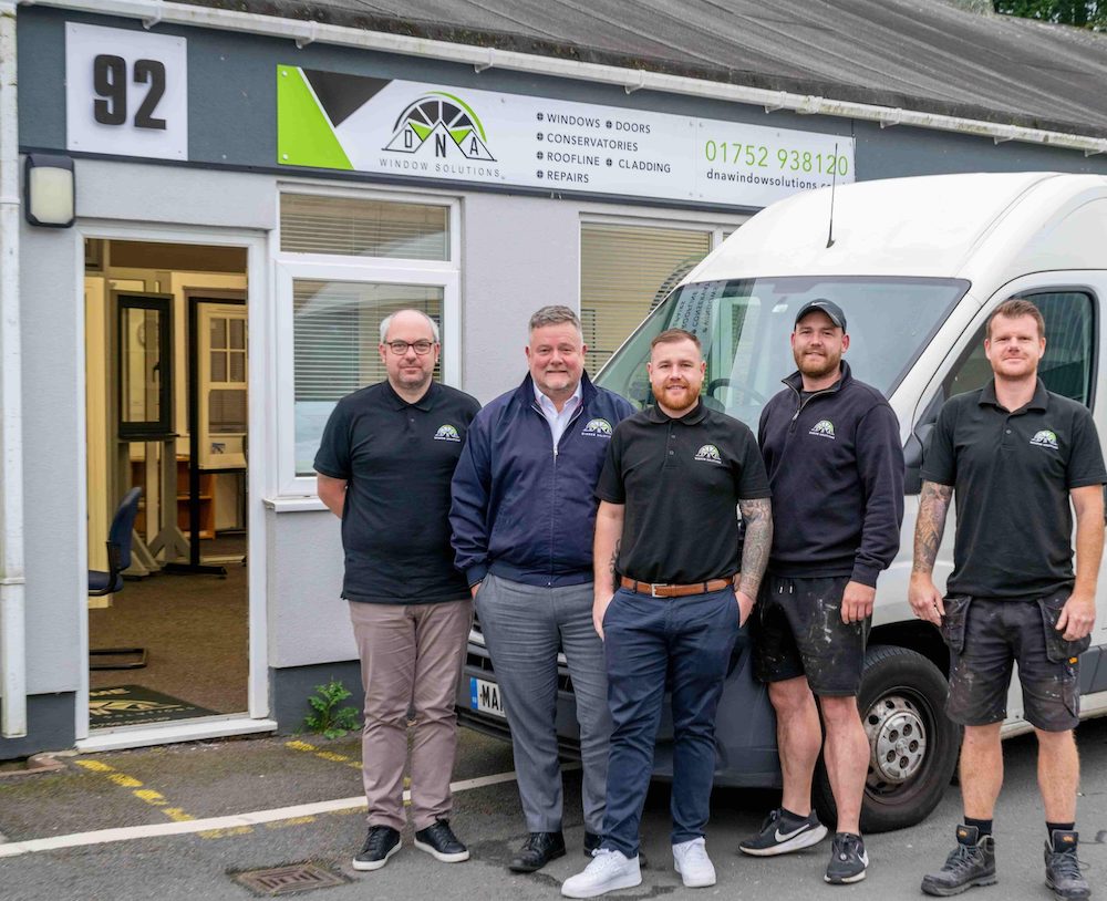 The DNA Window Solutions team standing outside their office, ready to provide expert window and door installations.