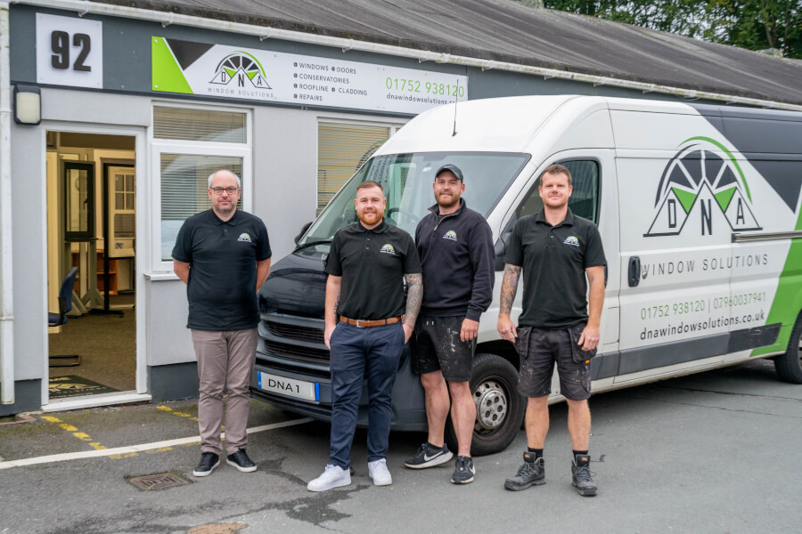 The DNA Window Solutions team standing outside their office, ready to provide expert window and door installations.