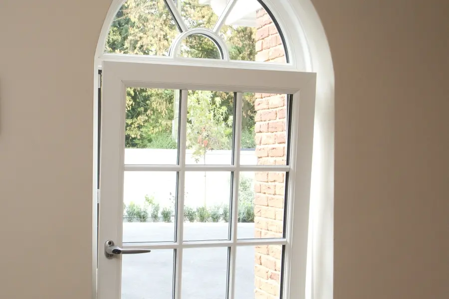 A Liniar 70mm tilt and turn window with an arched frame, offering a classic design with modern security and energy efficiency.